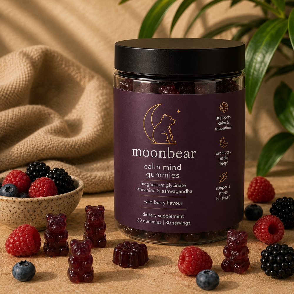 Moonbear Calm Mind Gummies jar (wild berry) with scattered berries and bear gummies